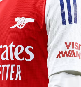 Arsenal players wearing jerseys with the "Visit Rwanda" logo, amid controversy over Rwanda’s alleged involvement in DRC conflict.