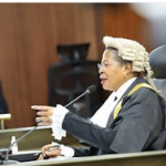 Dry, cracked land under intense sunlight in Uganda.