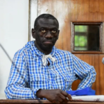 Ugandan military court in session with judges and legal teams.