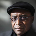 Strive Masiyiwa, African billionaire and founder of Econet Wireless, smiling in a business suit at a corporate event.