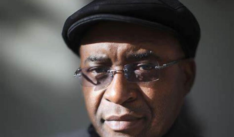 Strive Masiyiwa, African billionaire and founder of Econet Wireless, smiling in a business suit at a corporate event.