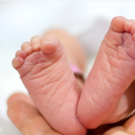 A Tanzanian mother and newborn receiving medical care under a health programme aimed at reducing maternal and infant mortality rates.