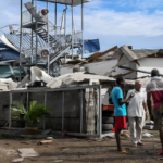 Aerial view of flood-stricken Seychelles with damaged infrastructure and rescue efforts underway.