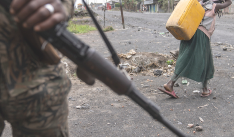 A disrupted trade route between East Africa and the Democratic Republic of Congo, showcasing halted trucks and affected traders.