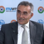 A professional portrait of Bilel Jamoussi, Deputy Director at ITU, discussing AI policy during an interview, symbolizing Africa's growing role in global AI governance.