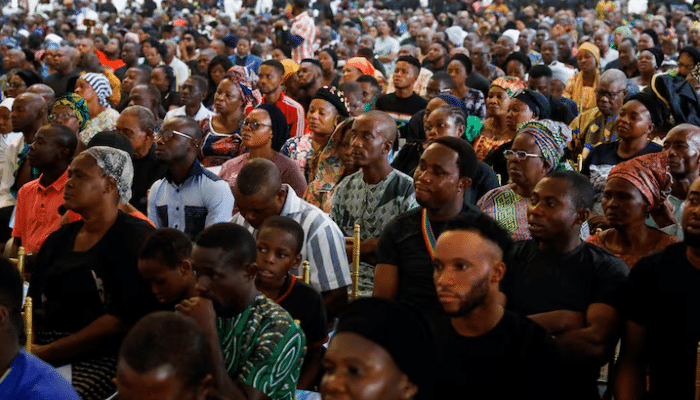 Mourners gather at St. Francis Catholic Church in Owo after 2022 attack.
