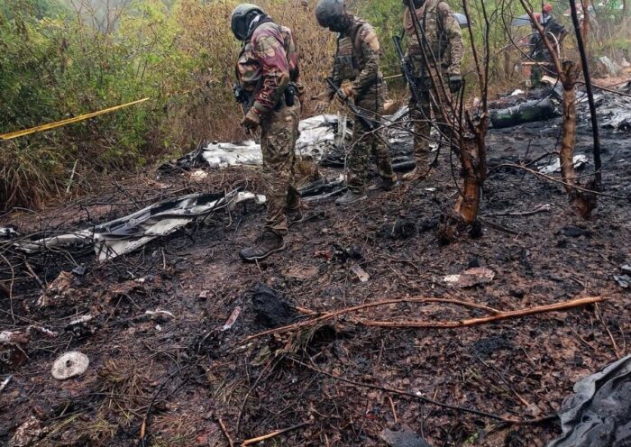 Kenyan rescue officials and investigators inspect the wreckage of a small passenger plane that crashed in Kwale County while en route to Maasai Mara, killing 11 foreign tourists.