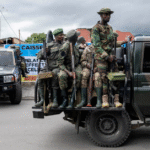 DR Congo envoy and M23 representative shake hands during a peace framework signing ceremony in Doha, observed by Qatar’s chief negotiator