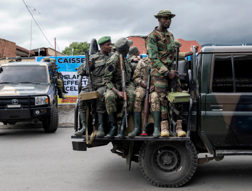 DR Congo envoy and M23 representative shake hands during a peace framework signing ceremony in Doha, observed by Qatar’s chief negotiator
