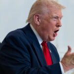 U.S. President Donald Trump speaks with service members from Mar-a-Lago during the Thanksgiving holiday.