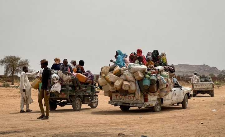 Displaced Sudanese women walk through the newly established El-Afadh camp in Northern State as UN officials warn of worsening humanitarian conditions.