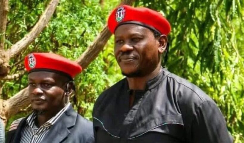 Kenyan activists Bob Njagi and Nicholas Oyoo raising their fists after returning to Nairobi following their secret detention in Uganda.