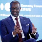 Tidjane Thiam speaking at an event, highlighting his journey from global business to Ivorian politics.