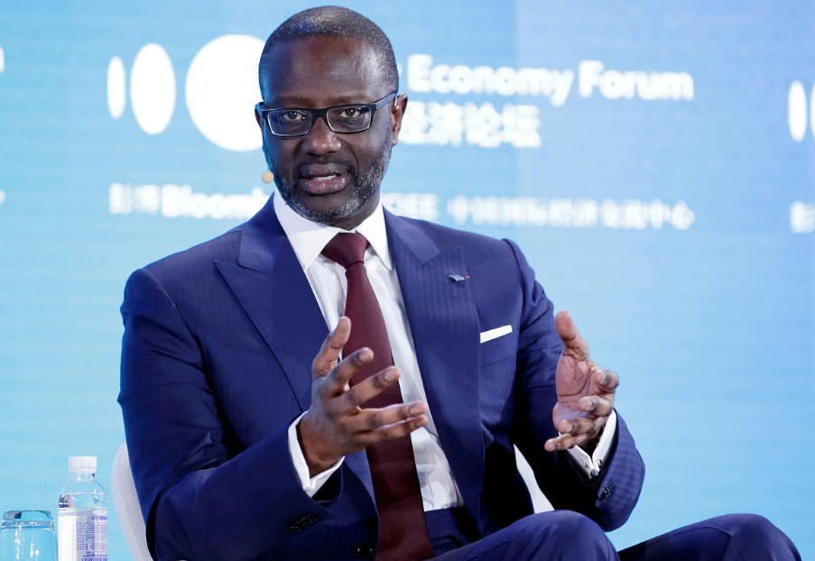 Tidjane Thiam speaking at an event, highlighting his journey from global business to Ivorian politics.