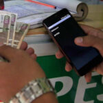 Mobile money users in Africa access digital financial services through their phones.