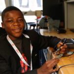 Kelvin Doe, a teenage inventor from Sierra Leone, working on electronics for K-Doe Tech.