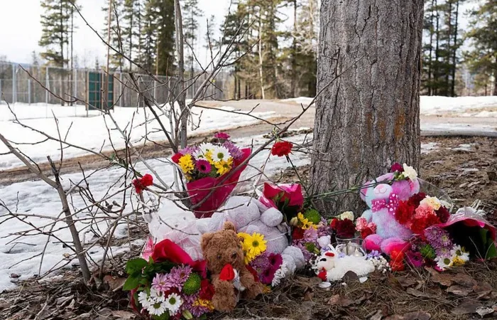 Police officers and emergency responders outside Tumbler Ridge Secondary School after a deadly shooting in Canada.